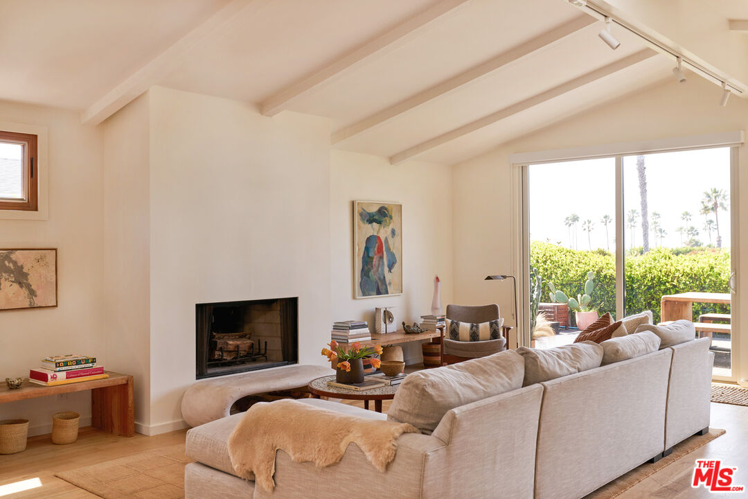 29500 Heathercliff Road, Unit 288 Malibu, CA 90265 - Photo 3 of 26 a living room with furniture large window and a fireplace