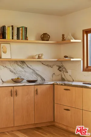 a view of a kitchen with wooden floor
