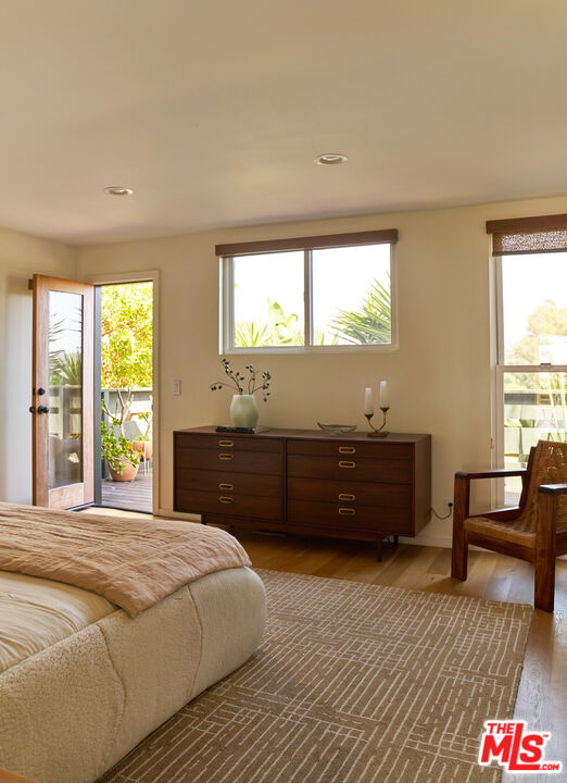 29500 Heathercliff Road, Unit 288 Malibu, CA 90265 - Photo 9 of 26 a bedroom with a bed and a dresser next to a window