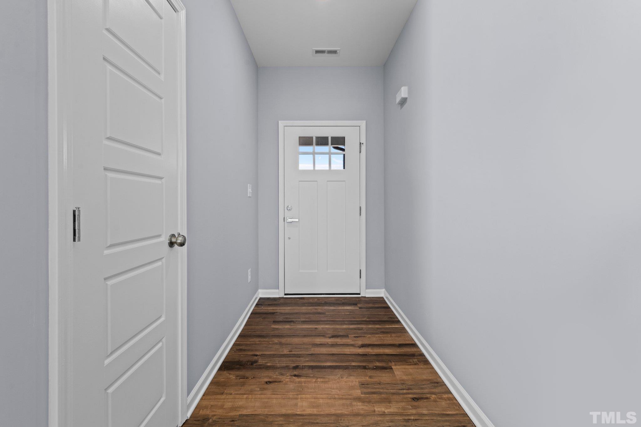 9695 Chapman Road Bailey, NC 27807 - Photo 3 of 26 a view of a hallway with wooden floor