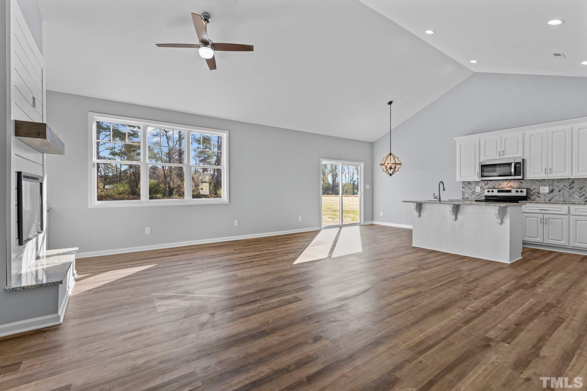 9695 Chapman Road Bailey, NC 27807 - Photo 5 of 26 a view of a kitchen with wooden floor electronic appliances and windows