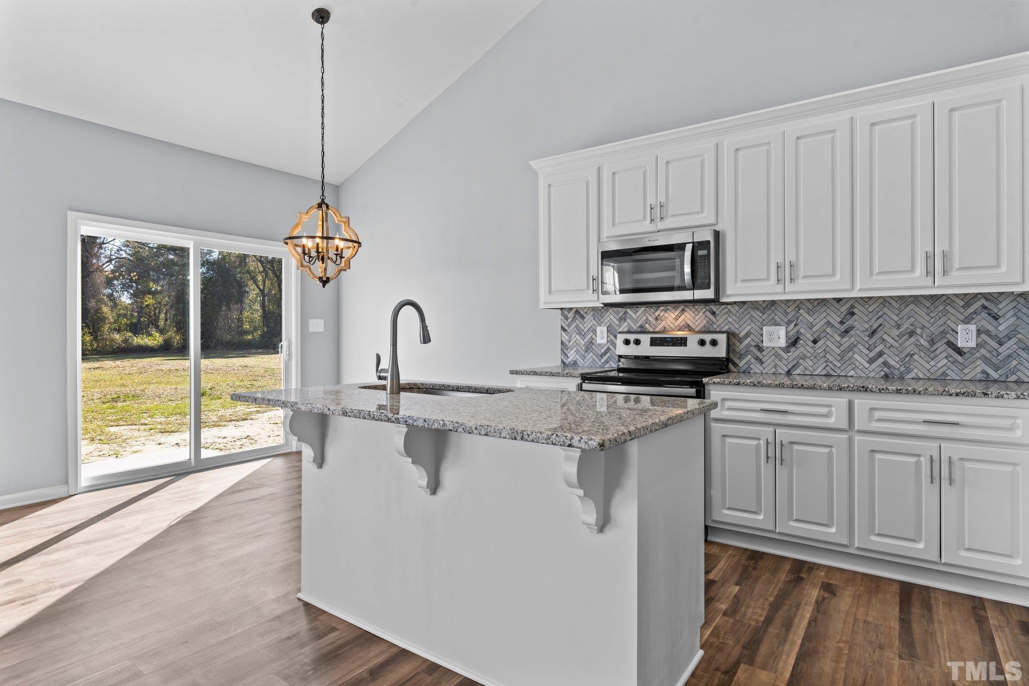 9695 Chapman Road Bailey, NC 27807 - Photo 7 of 26 a kitchen with appliances cabinets and a wooden floor