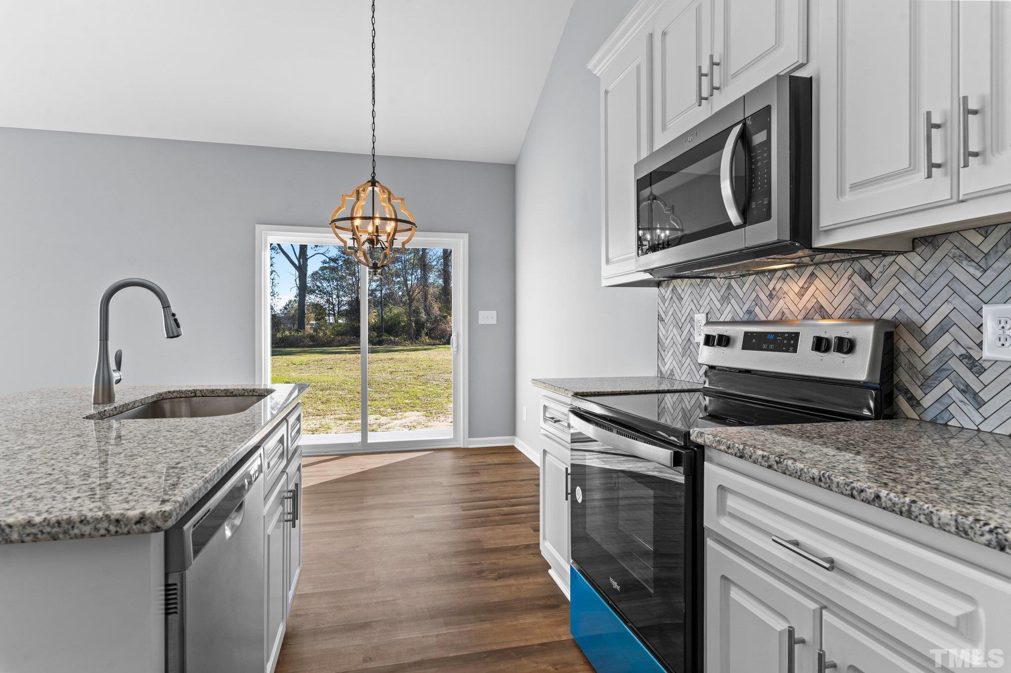 9695 Chapman Road Bailey, NC 27807 - Photo 8 of 26 a kitchen with granite countertop a stove and a sink