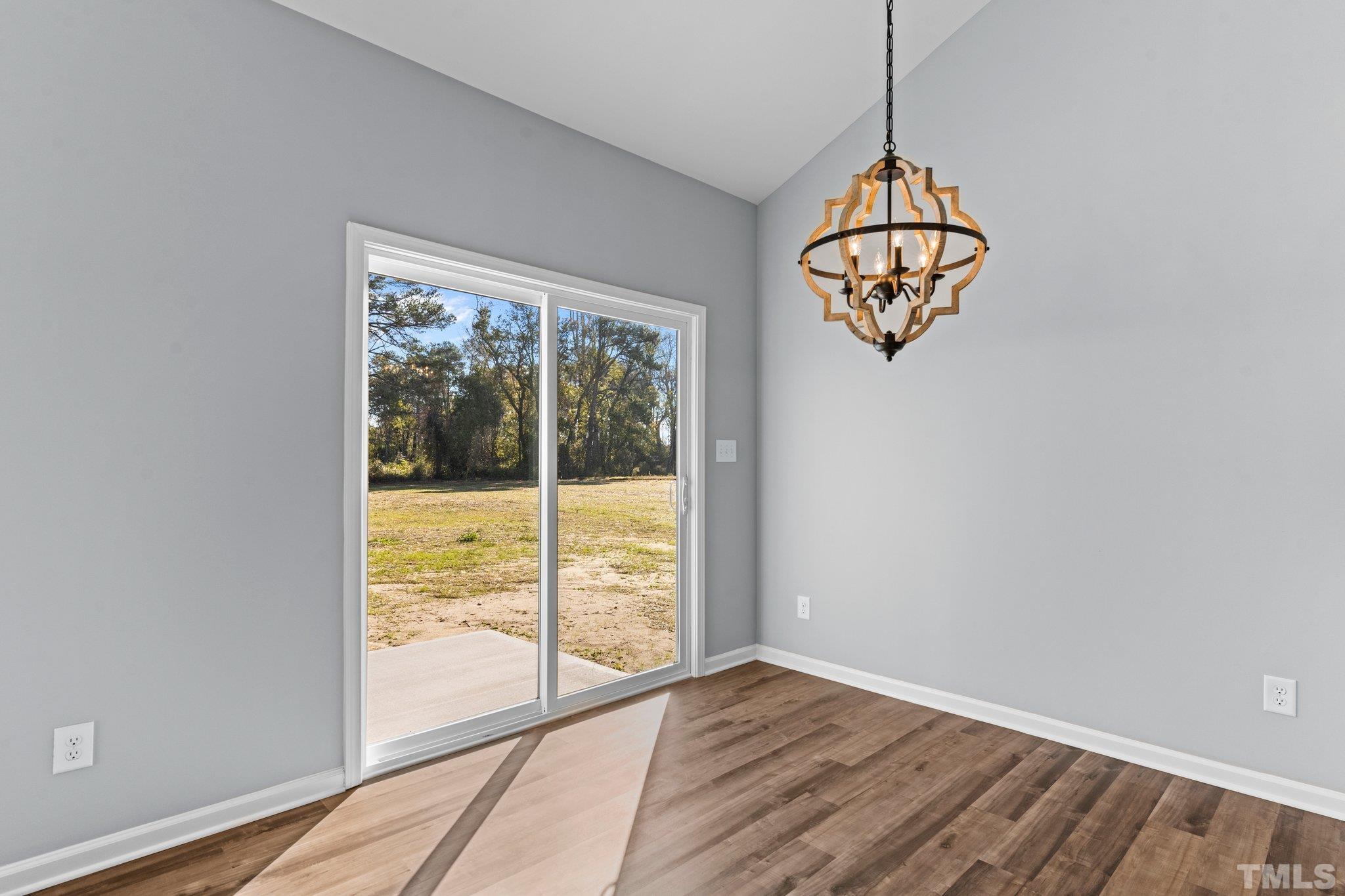 9695 Chapman Road Bailey, NC 27807 - Photo 10 of 26 a view of empty room with wooden floor and fan