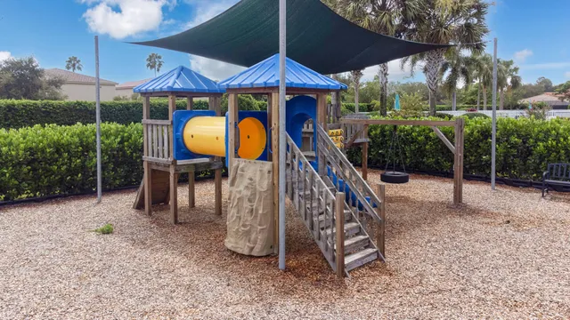 a view of a chairs and table in backyard