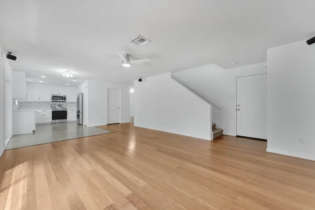 a view of an empty room with wooden floor
