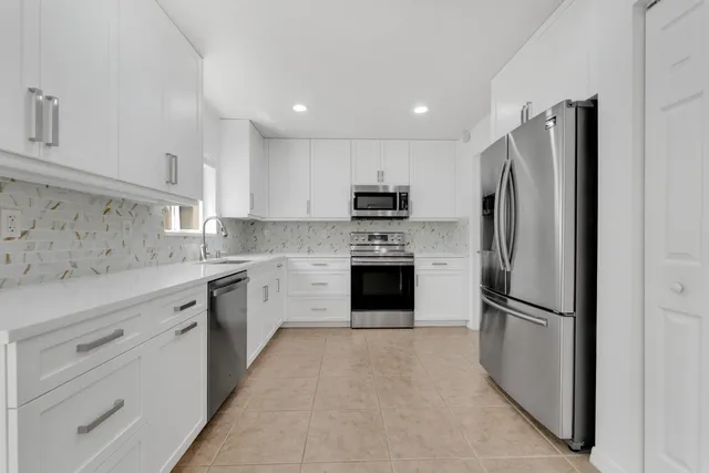 a kitchen with a refrigerator sink and microwave