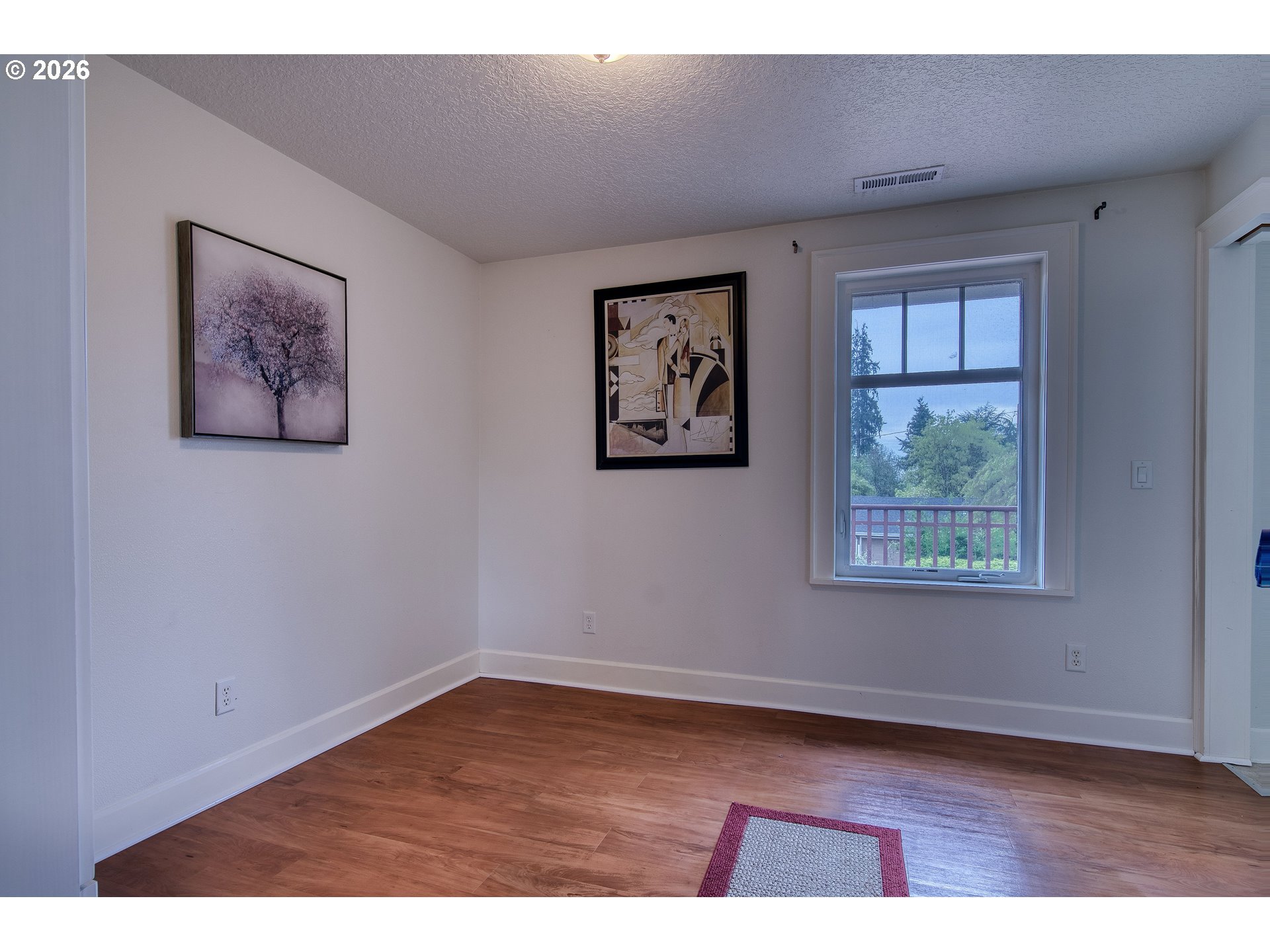 35432 Spence Street St. Helens, OR 97051 - Photo 18 of 48 a view of an empty room with a window and wooden floor