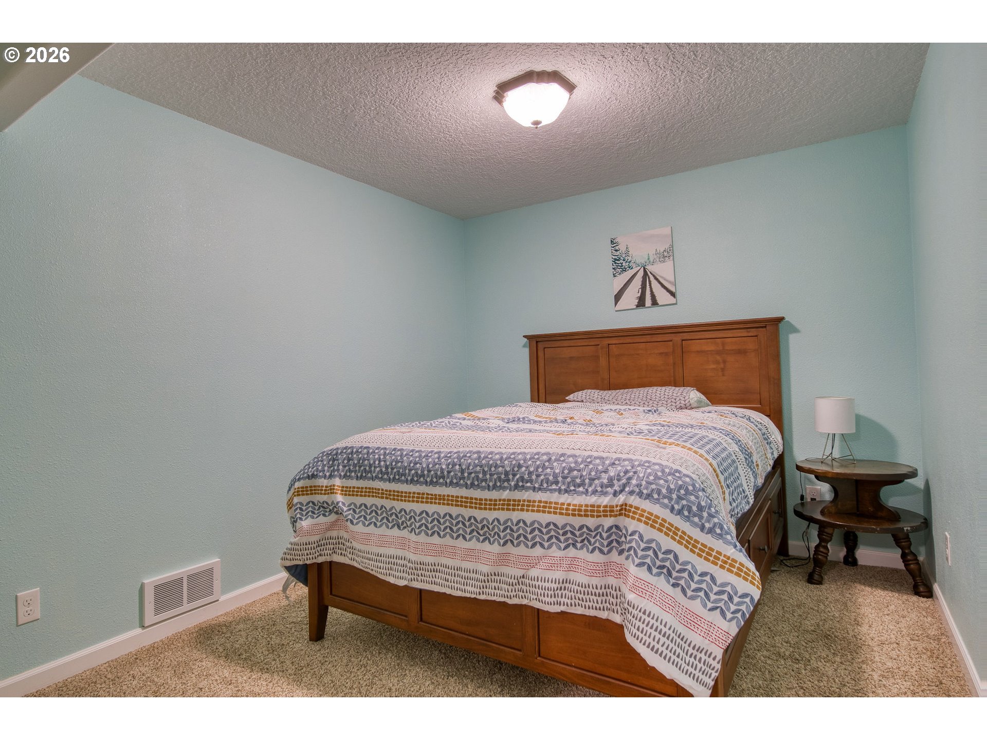 35432 Spence Street St. Helens, OR 97051 - Photo 22 of 48 a bedroom with a bed and a lamp