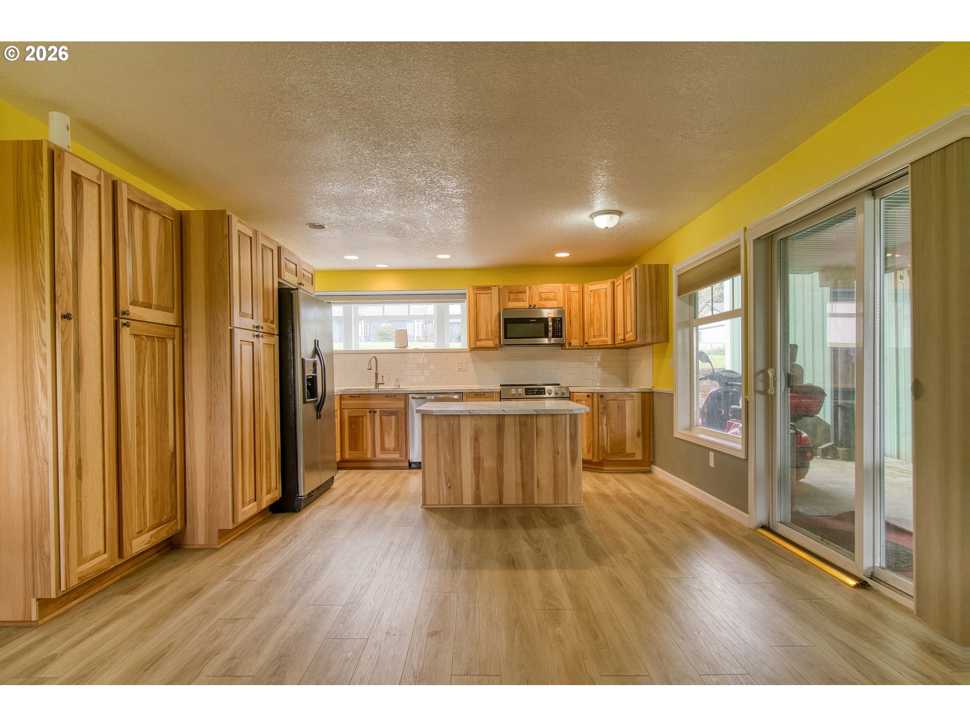 35432 Spence Street St. Helens, OR 97051 - Photo 25 of 48 a open kitchen with stainless steel appliances granite countertop a refrigerator a stove and a wooden floors