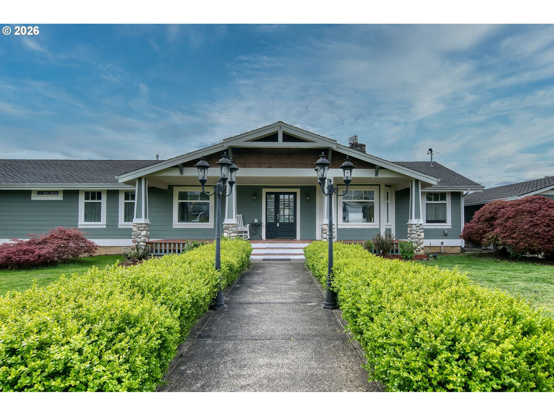 35432 Spence Street St. Helens, OR 97051 - Photo 3 of 48 a front view of a house with a garden and porch
