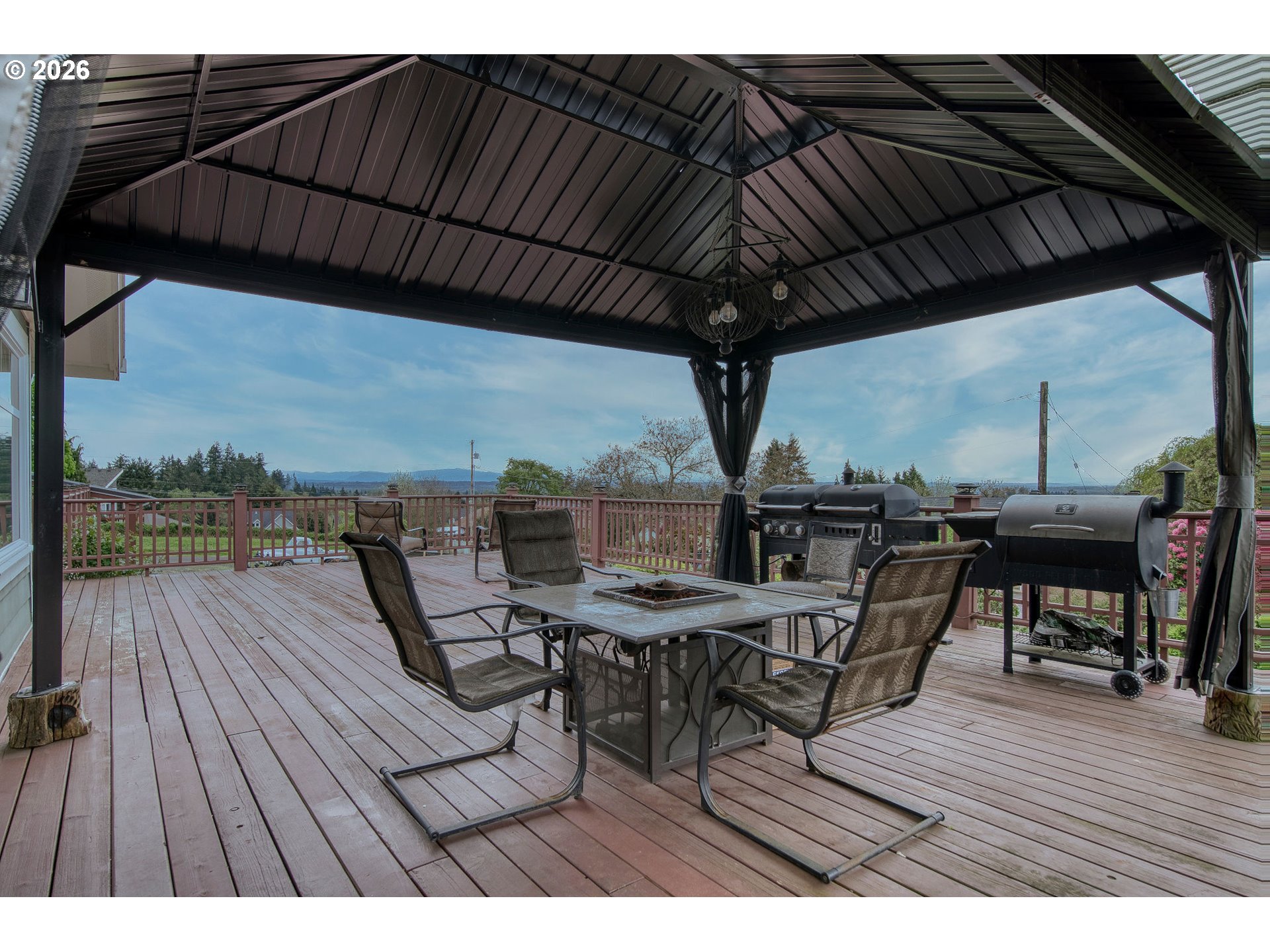 35432 Spence Street St. Helens, OR 97051 - Photo 34 of 48 a view of a roof deck with table and chairs under an umbrella with wooden floor