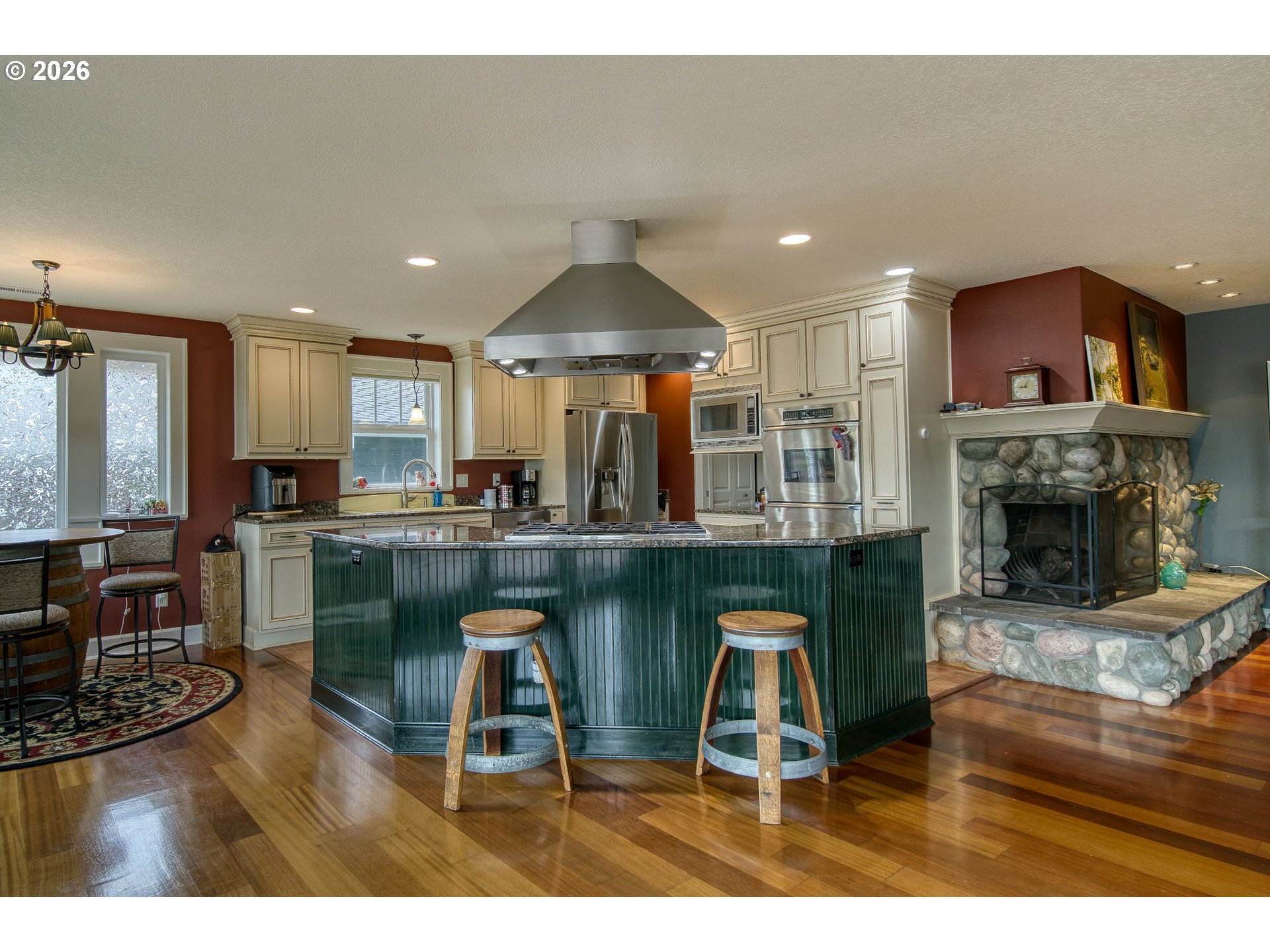 35432 Spence Street St. Helens, OR 97051 - Photo 6 of 48 a kitchen with stainless steel appliances granite countertop a table chairs a refrigerator and cabinets