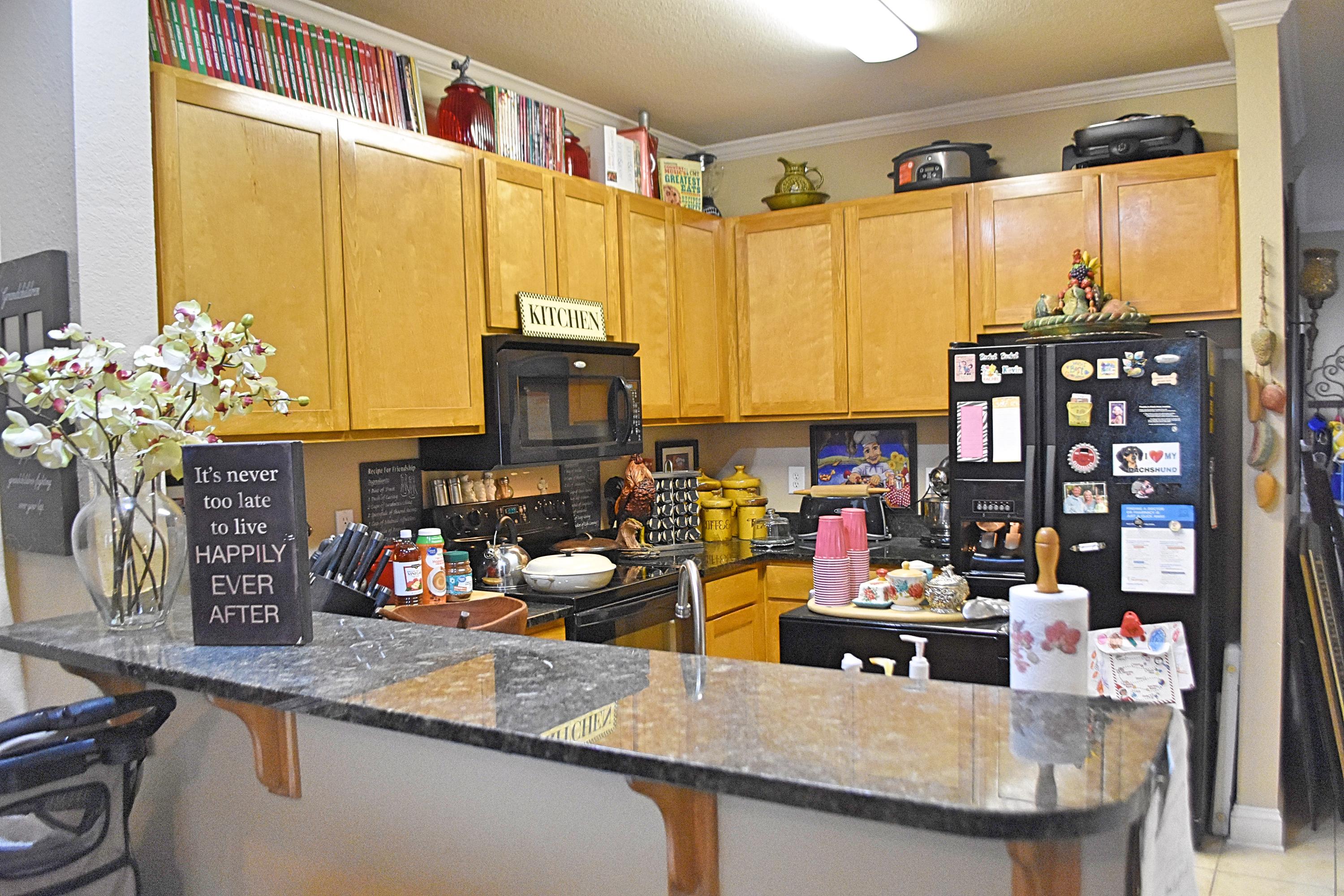 a kitchen with stainless steel appliances a sink a stove and a wooden floor