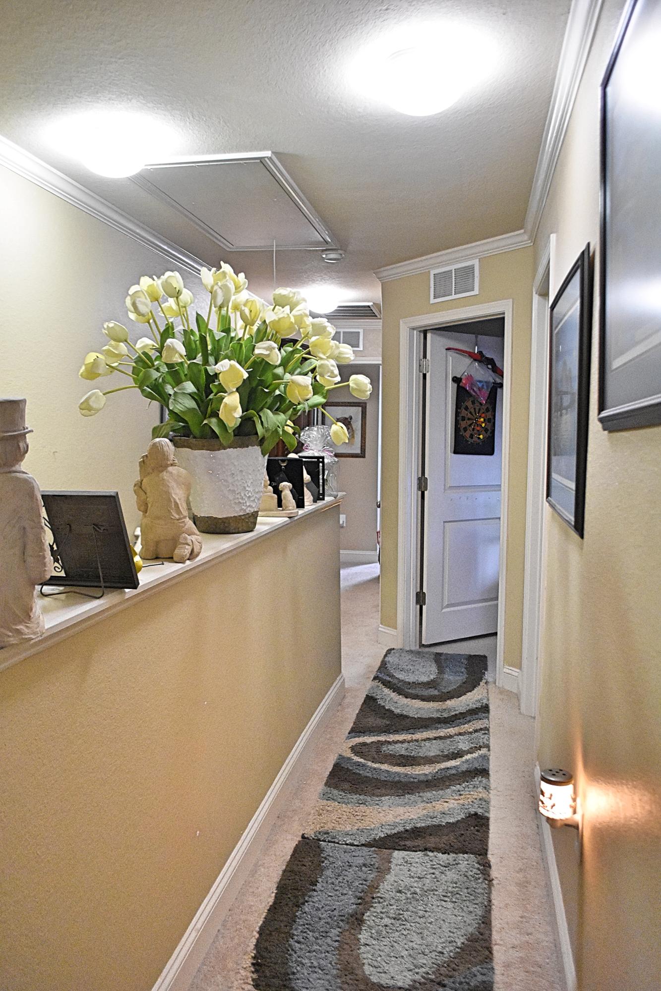 18 North Sand Palm Road, Unit 17 Freeport, FL 32439 - Photo 13 of 13 a view of a hallway with wooden floor and a potted plant