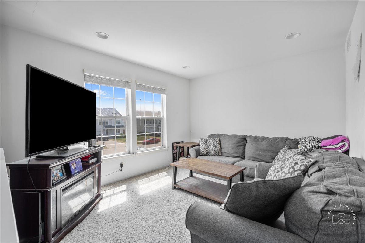 511 Silver Falls Street Joliet, IL 60431 - Photo 11 of 35 a living room with furniture and a flat screen tv