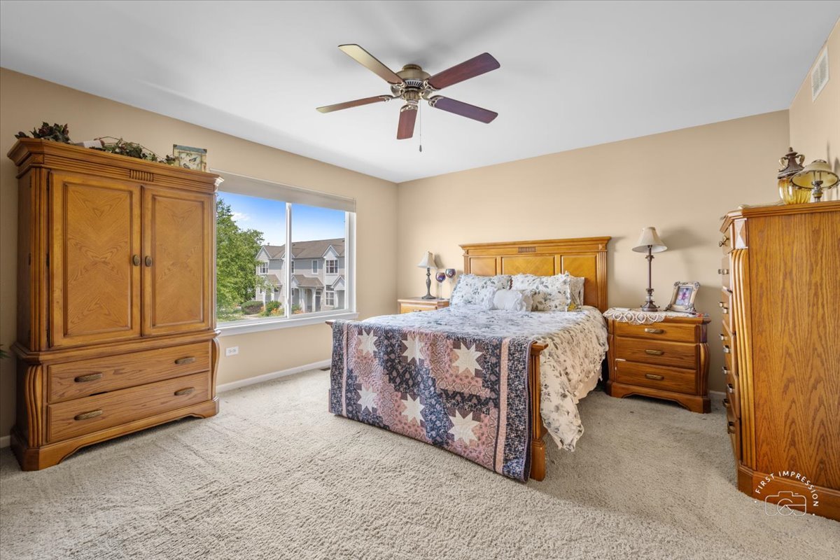 511 Silver Falls Street Joliet, IL 60431 - Photo 12 of 35 a bedroom with a bed dresser and a window