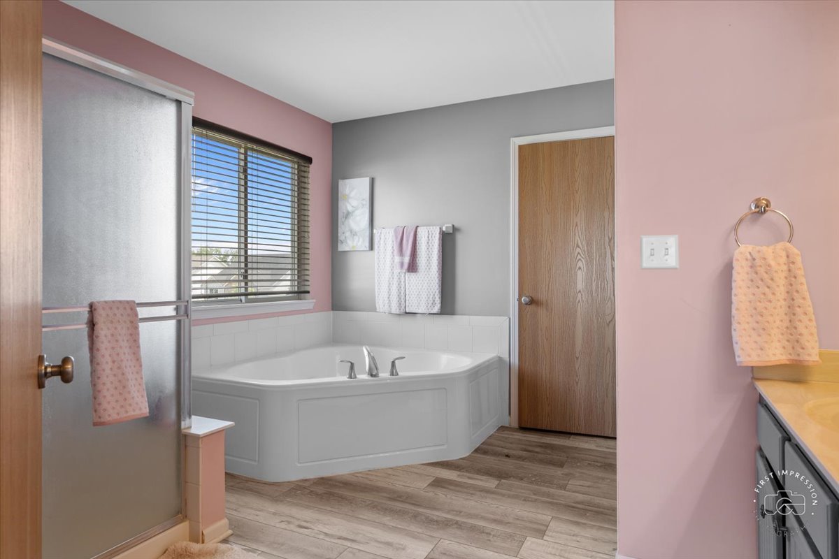 511 Silver Falls Street Joliet, IL 60431 - Photo 14 of 35 a bathroom with a bathtub and shower