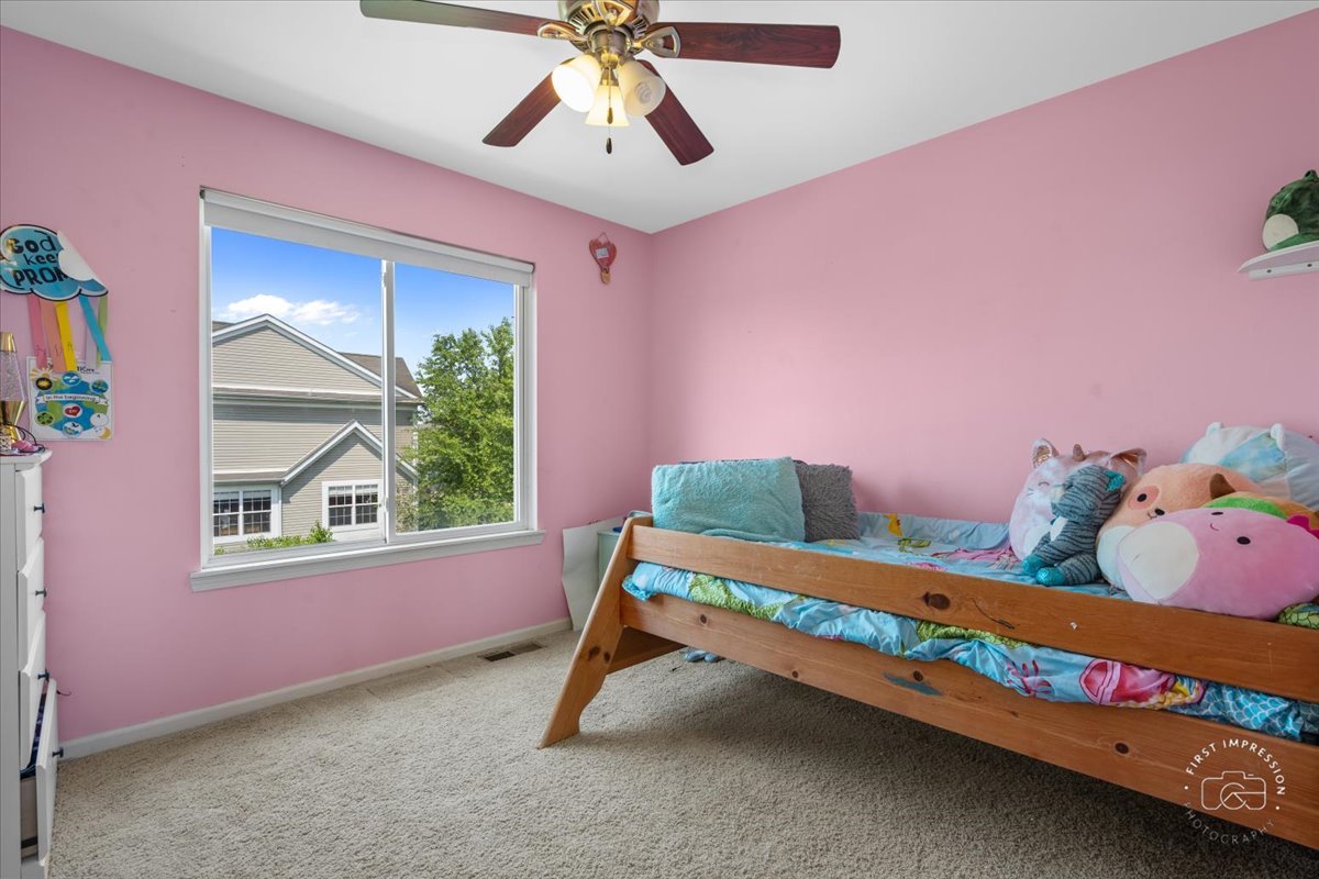 511 Silver Falls Street Joliet, IL 60431 - Photo 16 of 35 a bedroom with a bed and a window