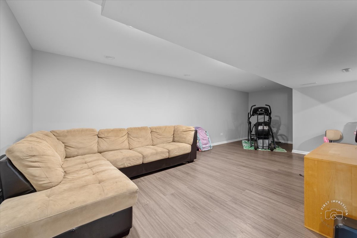 511 Silver Falls Street Joliet, IL 60431 - Photo 18 of 35 a living room with furniture and wooden floor