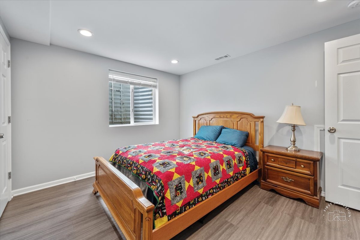 511 Silver Falls Street Joliet, IL 60431 - Photo 21 of 35 a bedroom with a bed and a lamp on table