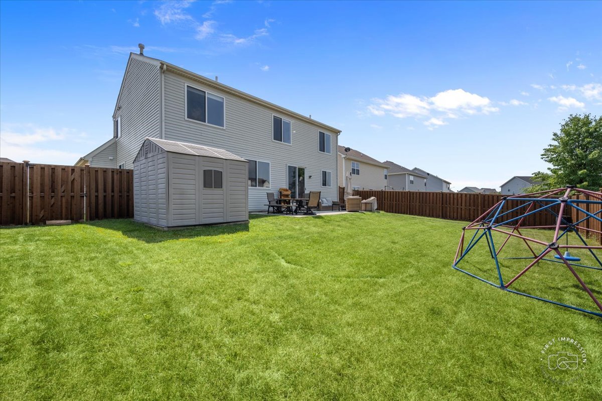 511 Silver Falls Street Joliet, IL 60431 - Photo 26 of 35 a backyard of a house with table and chairs