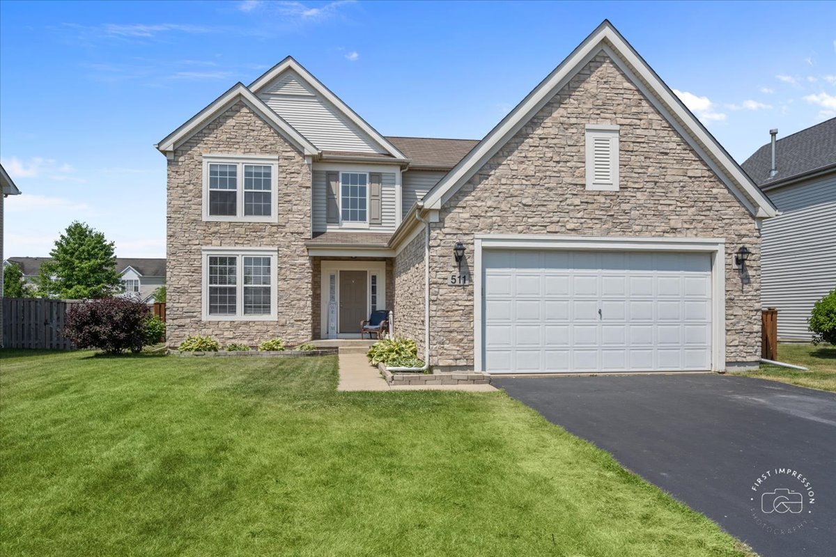 511 Silver Falls Street Joliet, IL 60431 - Photo 29 of 35 a front view of a house with a yard and garage