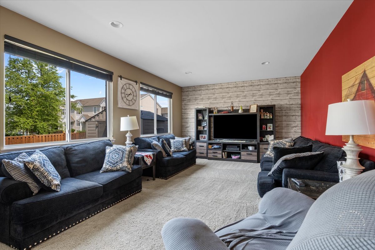511 Silver Falls Street Joliet, IL 60431 - Photo 7 of 35 a living room with furniture a flat screen tv and a large window