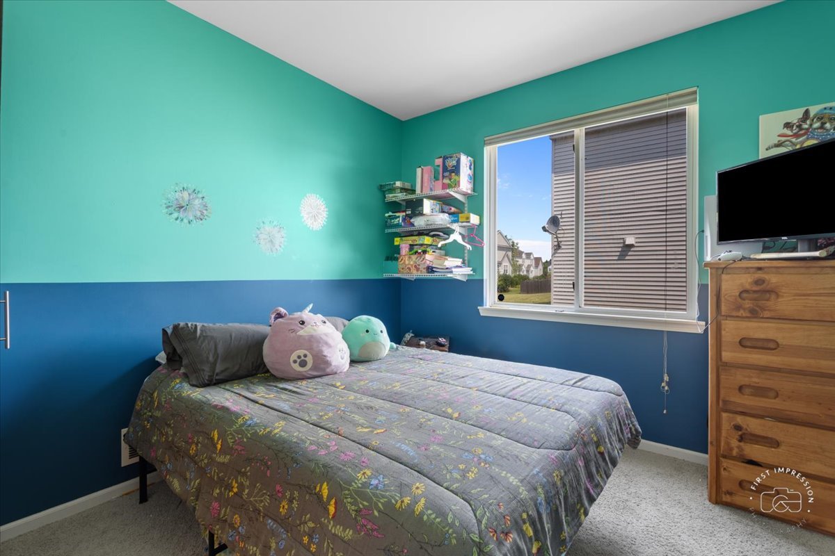 511 Silver Falls Street Joliet, IL 60431 - Photo 9 of 35 a bedroom with a bed and a television