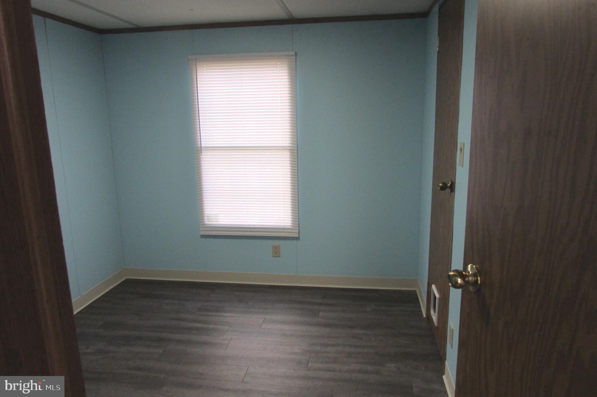 12222 Polktown Road Waynesboro, PA 17268 - Photo 11 of 22 an empty room with wooden floor and windows