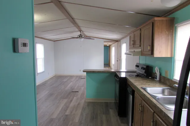 a kitchen with green cabinets a sink and a stove top oven