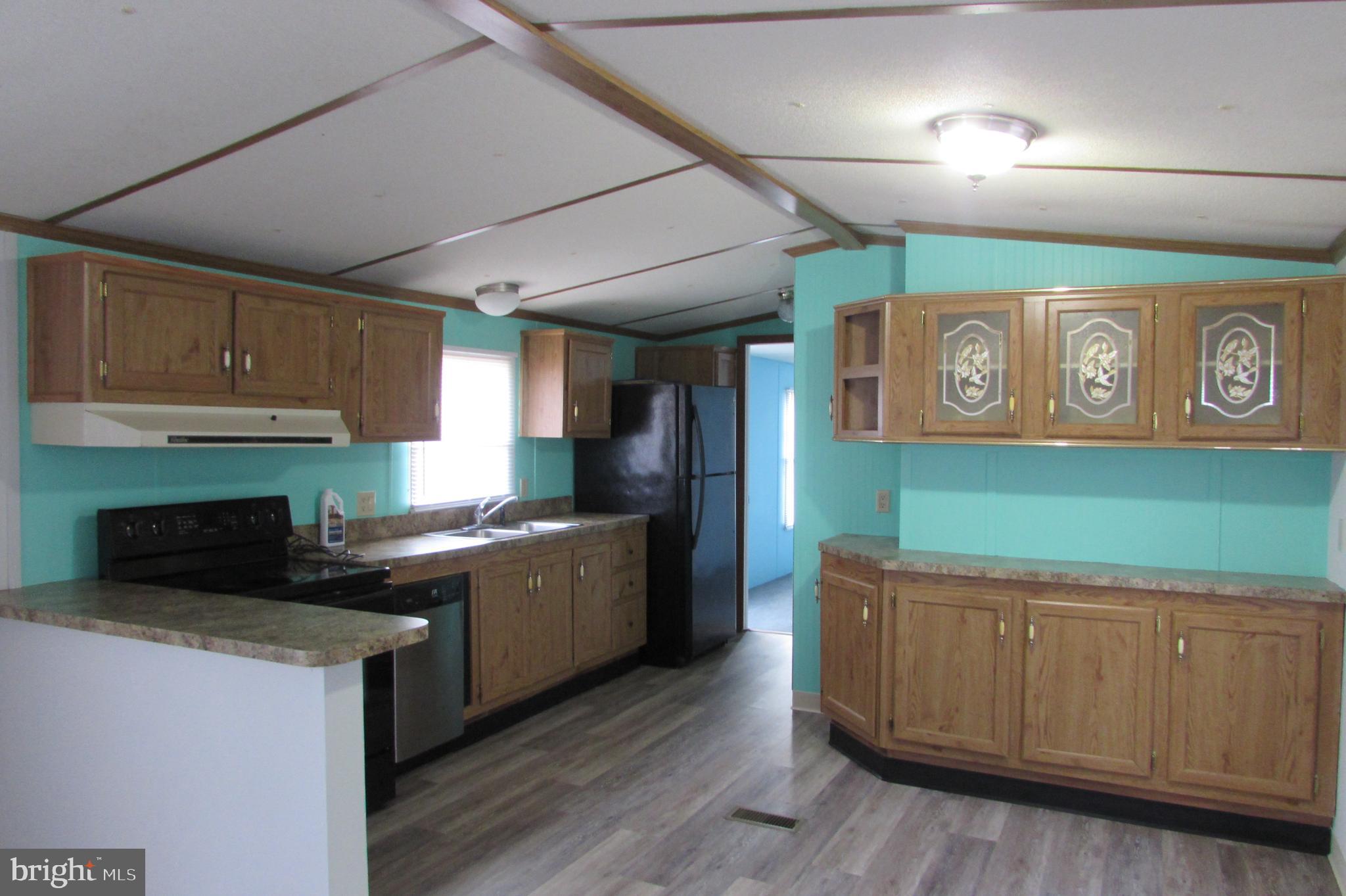 12222 Polktown Road Waynesboro, PA 17268 - Photo 4 of 22 a kitchen with stainless steel appliances granite countertop a stove a sink and a refrigerator