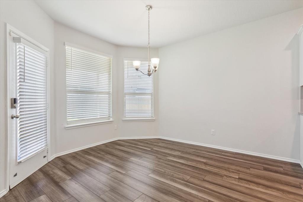 3220 Marston Road Lorena, TX 76655 - Photo 12 of 40 an empty room with wooden floor and windows