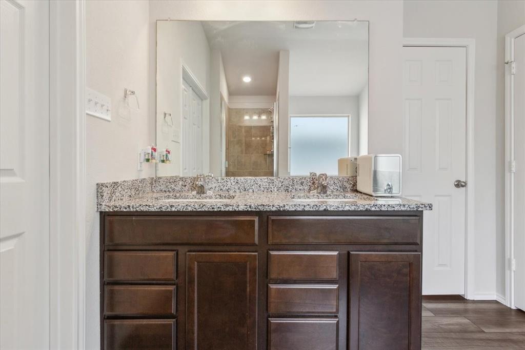 3220 Marston Road Lorena, TX 76655 - Photo 24 of 40 a bathroom with a granite countertop sink and a mirror