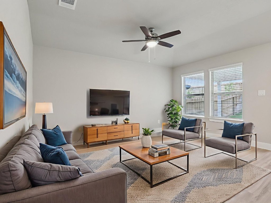 305 Gristmill Road Burnet, TX 78611 - Photo 10 of 21 Photo is not of the actual home, but is an inspirational photo of builder’s model home and may depict options, furnishings, and/or decorator features that are not includedLiving room featuring light wood-type flooring and ceiling fan