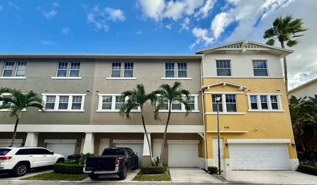 a couple of cars parked in front of a building