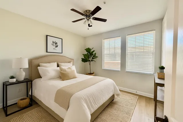 a bedroom with bed and a large window