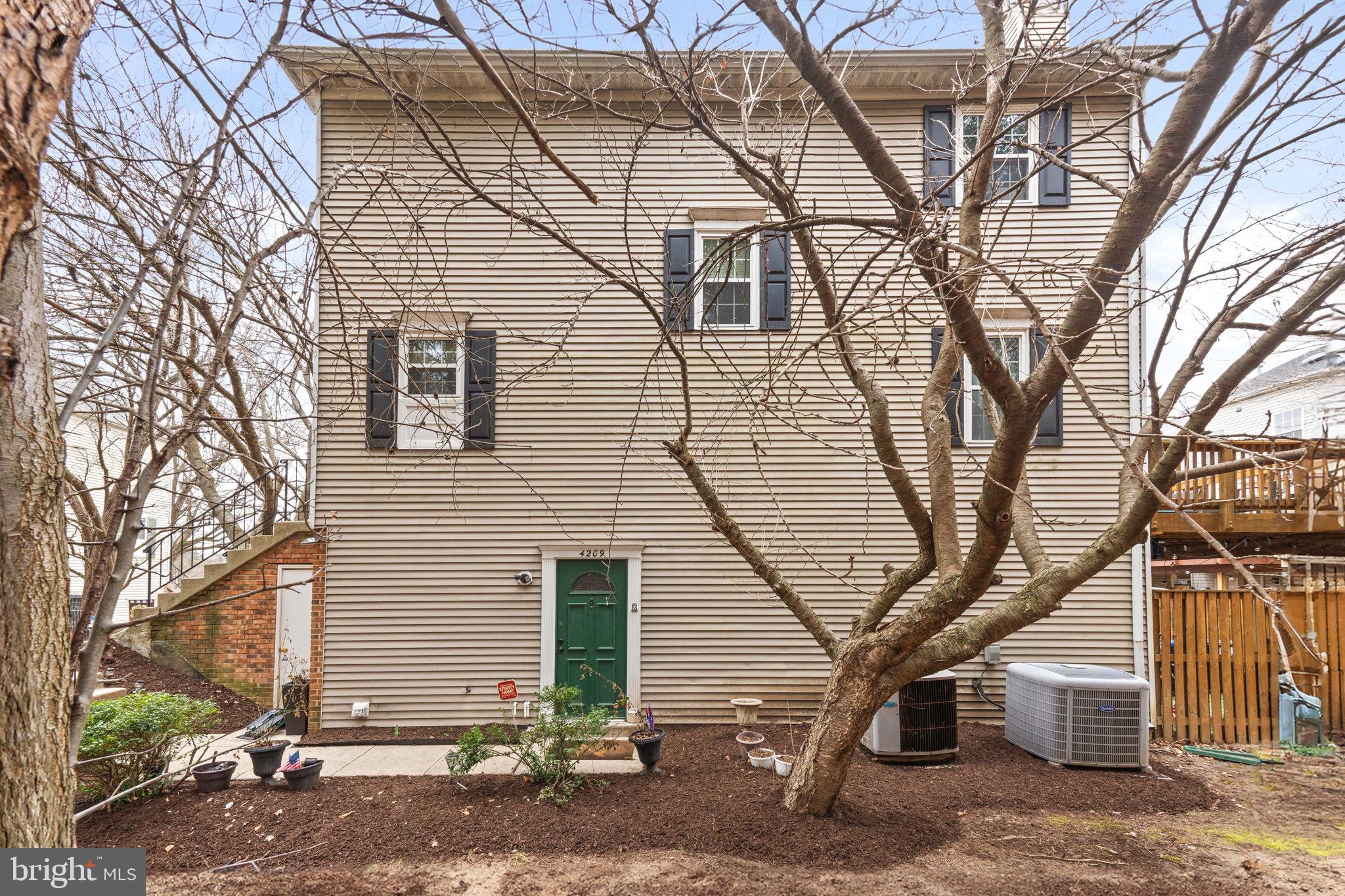 4209 Stockbridge Drive Dumfries, VA 22025 - Photo 1 of 26 a front view of a house with a tree