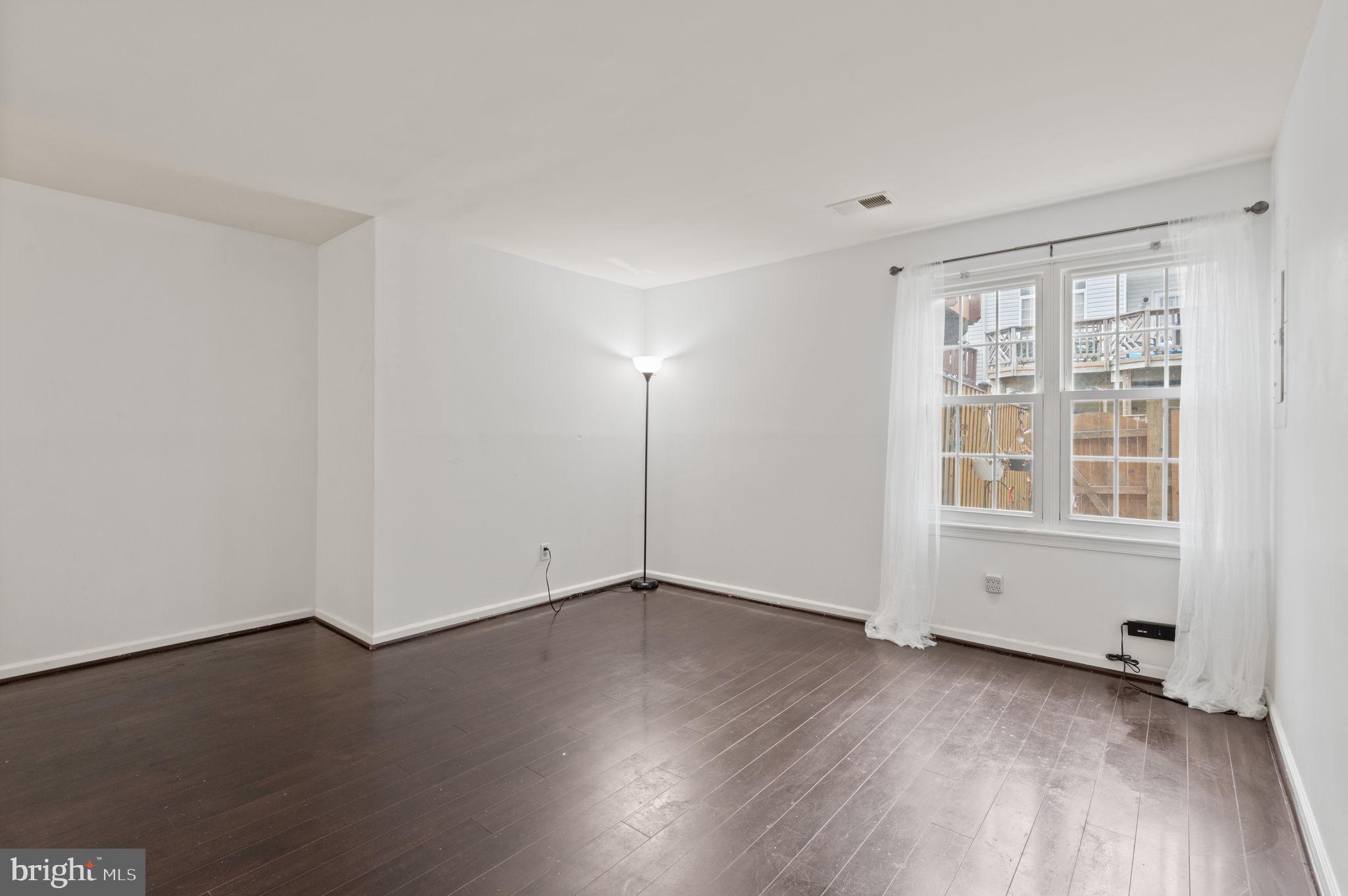 4209 Stockbridge Drive Dumfries, VA 22025 - Photo 12 of 26 an empty room with wooden floor and windows