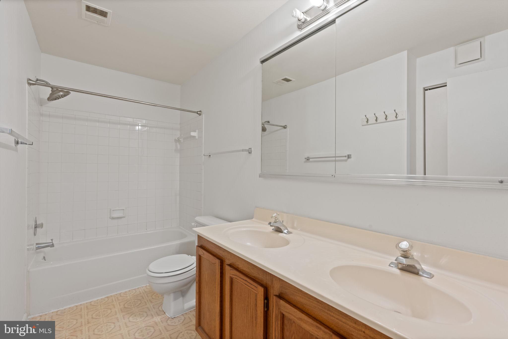 4209 Stockbridge Drive Dumfries, VA 22025 - Photo 17 of 26 a bathroom with a sink toilet a vanity and shower