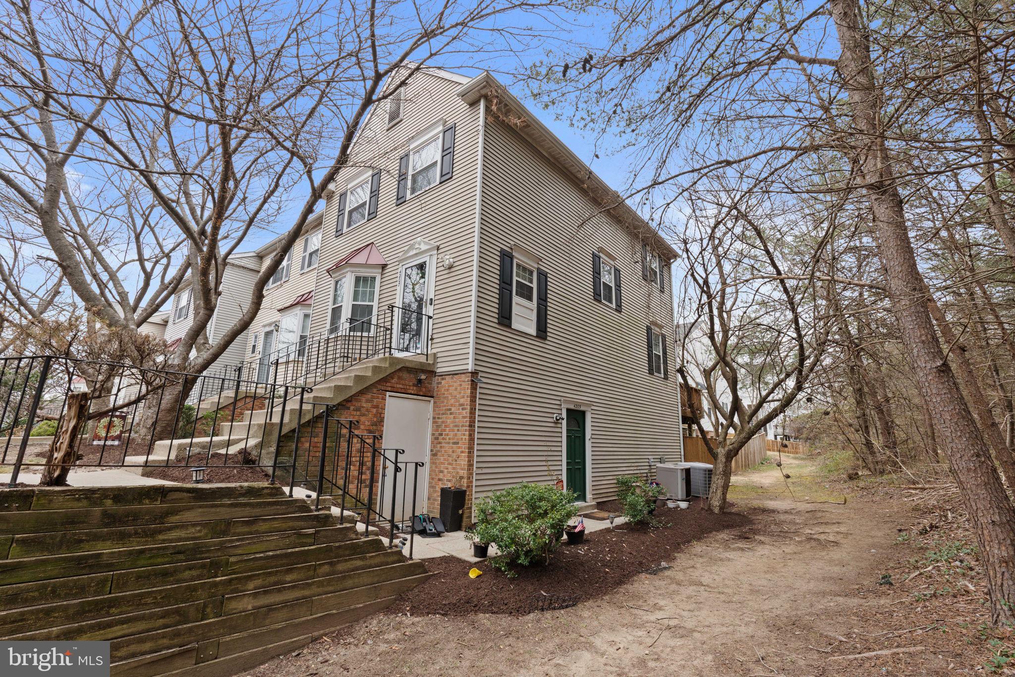 4209 Stockbridge Drive Dumfries, VA 22025 - Photo 2 of 26 a front view of a house with a yard