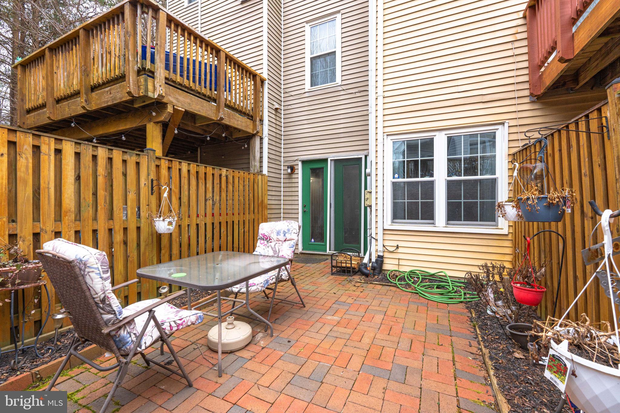 4209 Stockbridge Drive Dumfries, VA 22025 - Photo 24 of 26 a view of a chairs and table in the back yard of the house