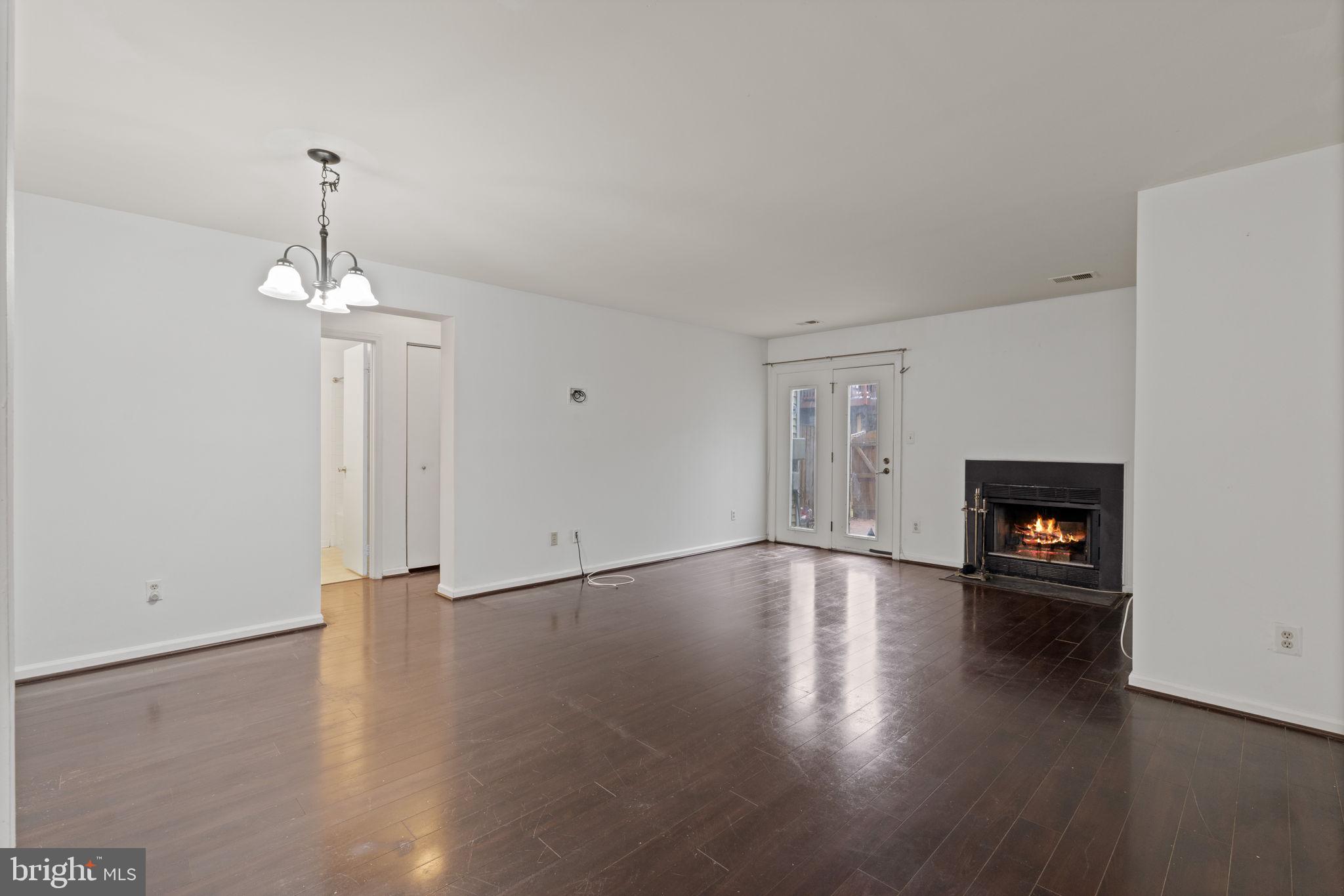 4209 Stockbridge Drive Dumfries, VA 22025 - Photo 5 of 26 an empty room with wooden floor fireplace and window