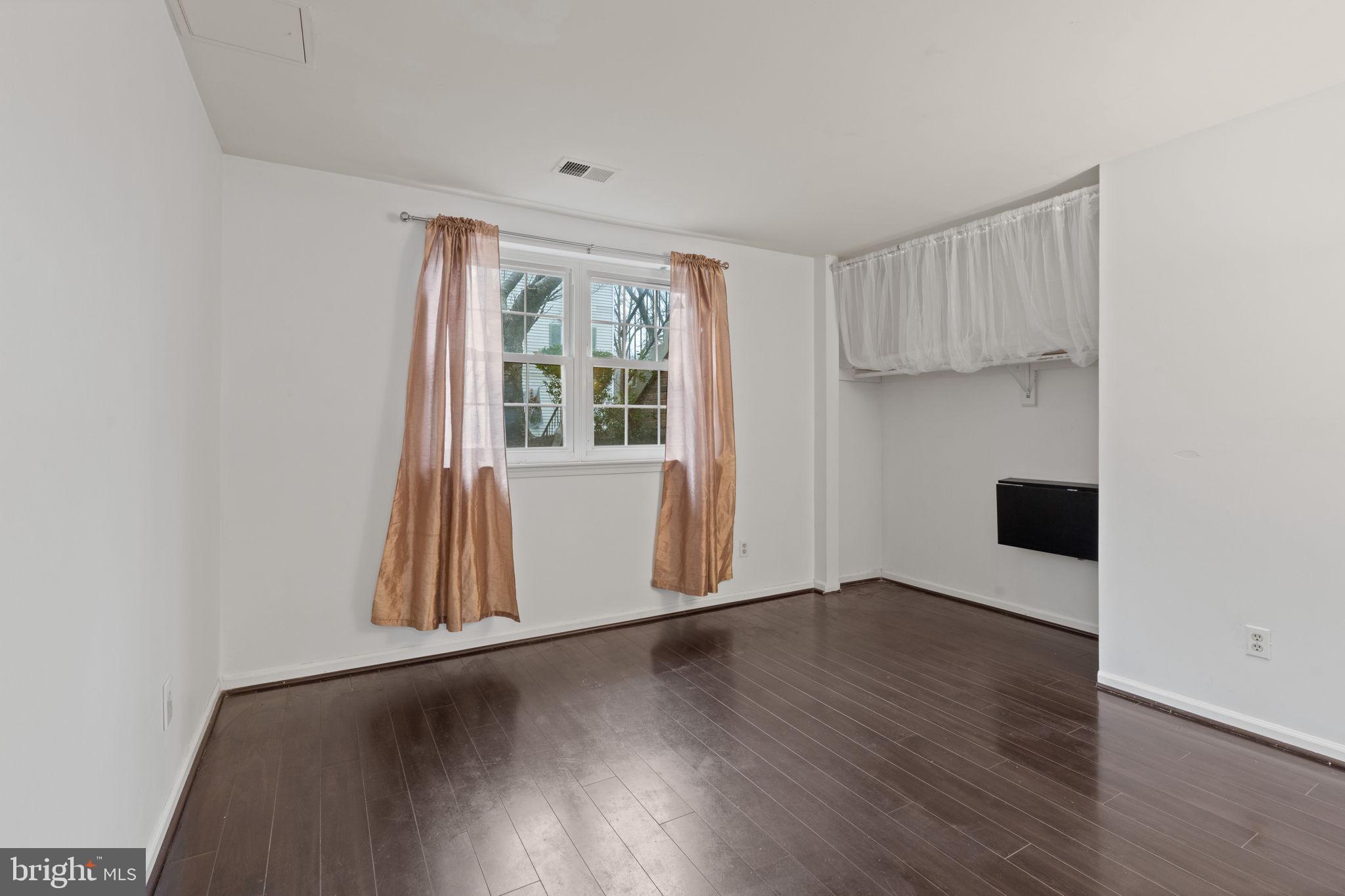 4209 Stockbridge Drive Dumfries, VA 22025 - Photo 10 of 26 an empty room with wooden floor and windows