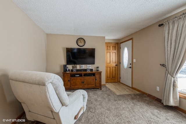 9003 Krunfus Road Harvard, IL 60033 - Photo 3 of 16 a living room with furniture and a flat screen tv