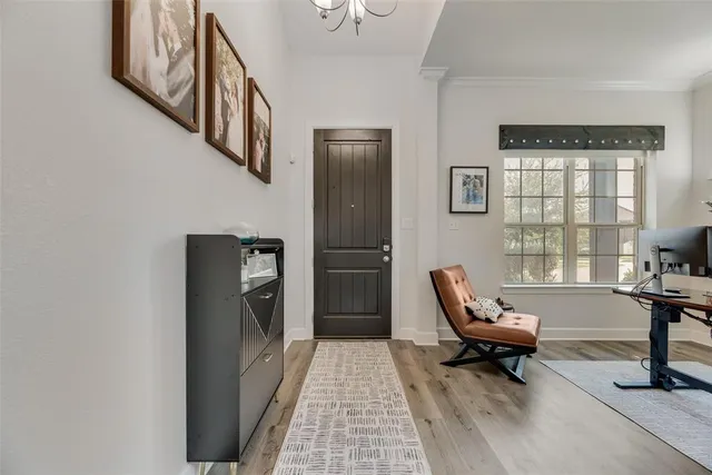 a living room with furniture a fireplace and a large window