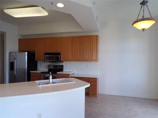 a kitchen with a sink and a refrigerator
