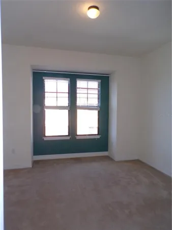 an empty room with a empty space and windows