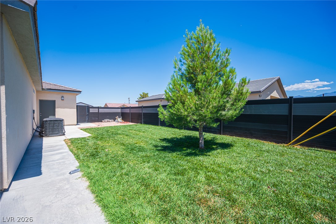 441 Belville Road Pahrump, NV 89048 - Photo 37 of 44 A well-maintained yard provides a serene outdoor retreat, fully fenced for privacy.
