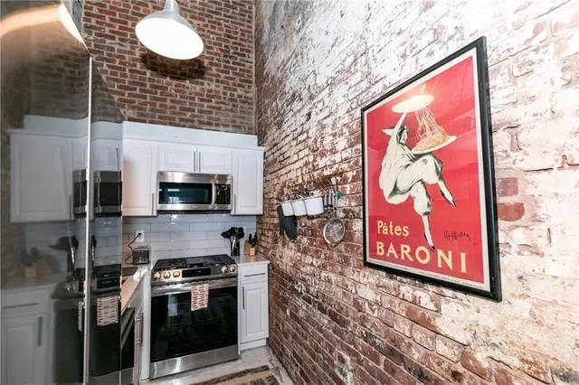 a kitchen with stainless steel appliances a stove top oven a sink and cabinets